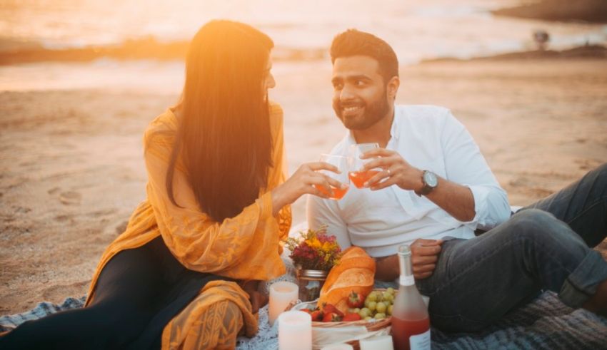 A couple enjoying a picnic on the beach.