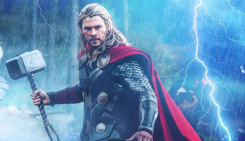 Thor is standing in the rain with a hammer.