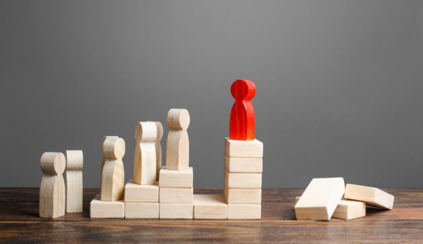 A group of wooden blocks with a red person standing on top of them.