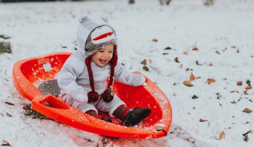 A child is riding a sled in the snow.