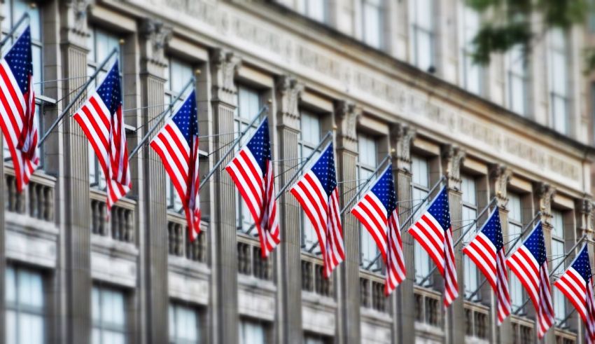 A row of american flags on the side of a building.