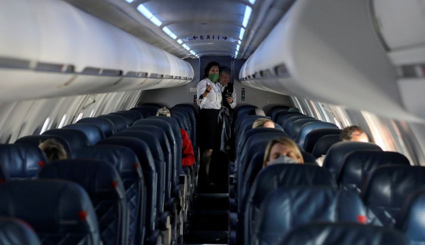 The inside of an airplane with people sitting in the seats.