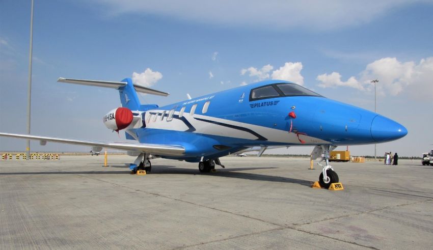 A blue and white airplane parked on the tarmac.