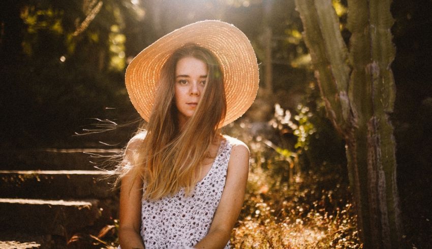 A woman wearing a straw hat in the sun.