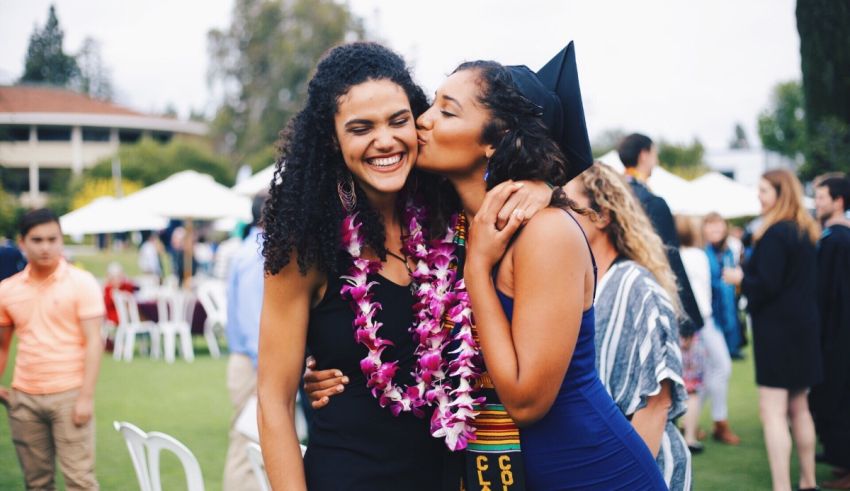 Two women hugging at a graduation ceremony.