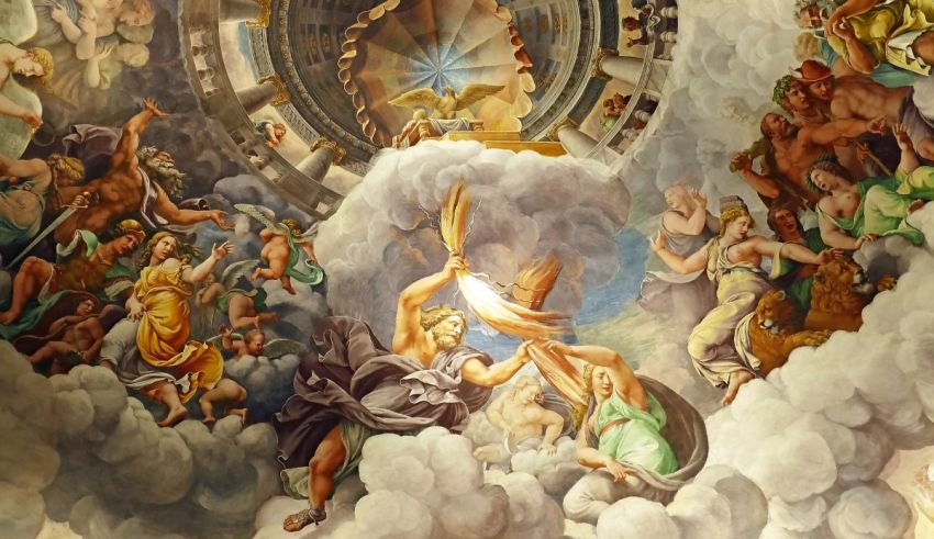 A painting of angels and demons in the ceiling of a church.
