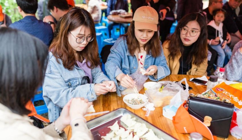 A group of people sitting around a table eating food.