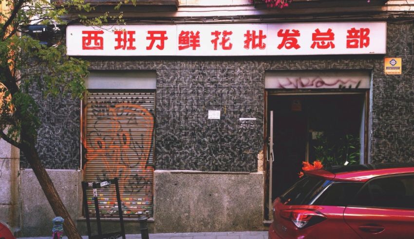 A red car parked in front of a building.