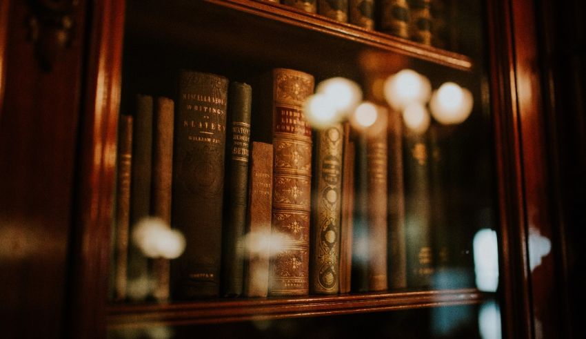 A bookcase full of books in a dark room.