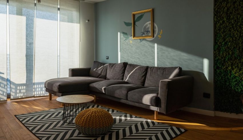 A living room with a gray couch and a chevron rug.