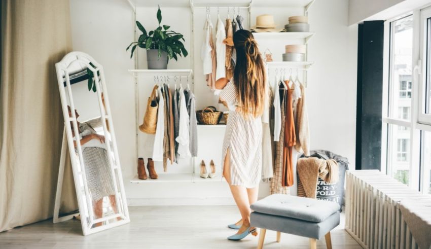 A woman looking at her clothes in a closet.