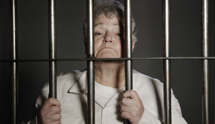 An older woman in a jail cell.