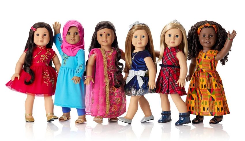 A group of american girl dolls standing together.
