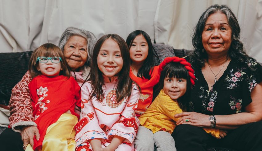 A group of asian women and children posing for a photo.