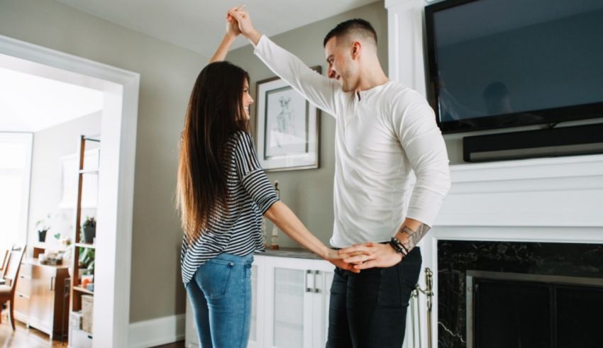 Young couple dancing in the living room.