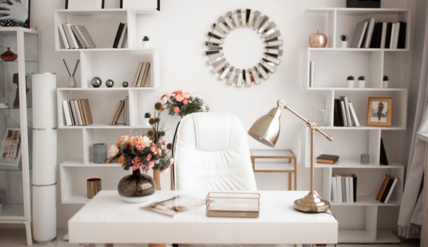 A white office with bookshelves and flowers.