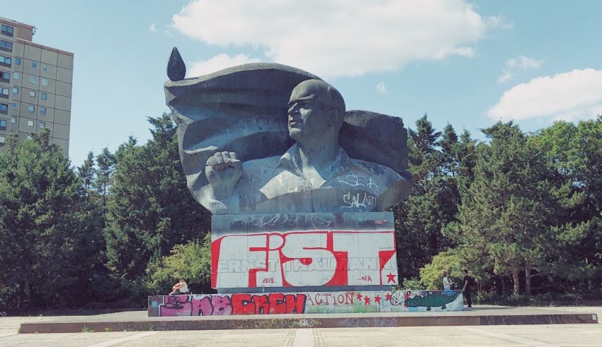 A statue of a man with graffiti on it.