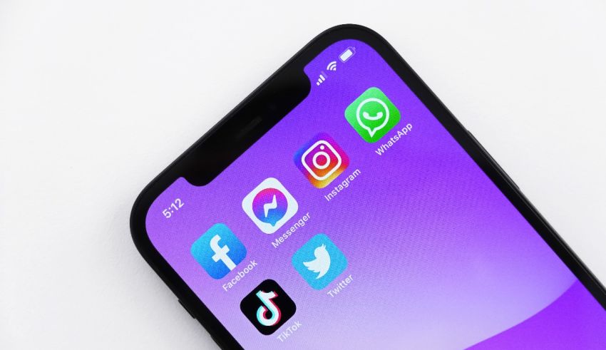 A purple iphone with social media icons on it.