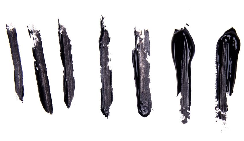 A group of black eyeliner pencils on a white background.