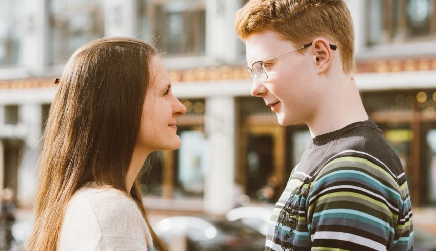 A young couple looking at each other in the street.
