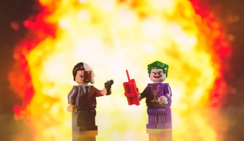 Two lego figures standing in front of a fire.