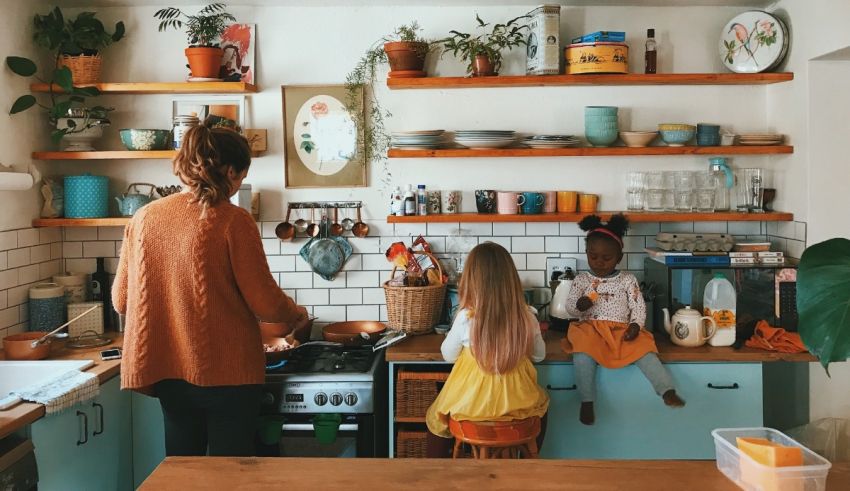 A woman and two children in a kitchen.