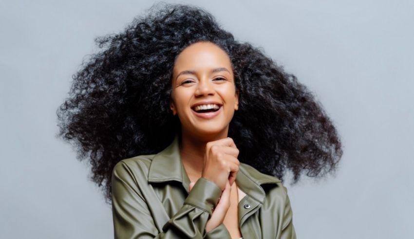 A smiling black woman with afro hair.