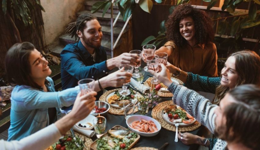 A group of friends toasting at a dinner table.