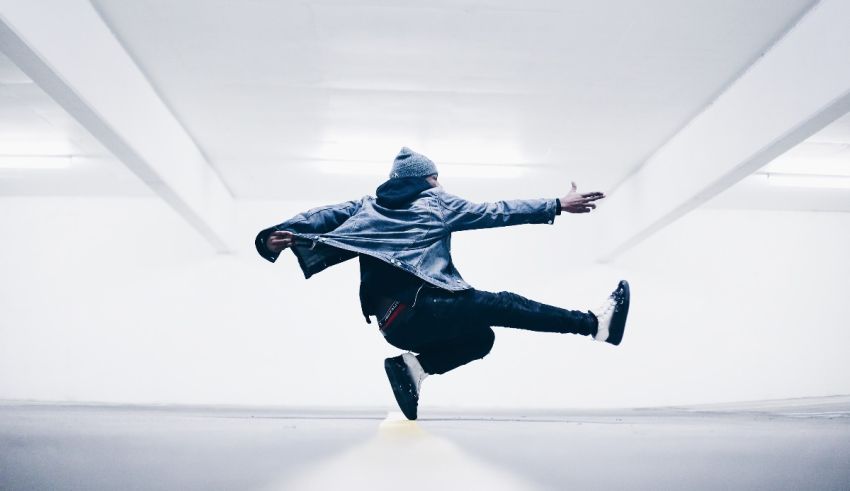 A man jumping in the air in a parking garage.