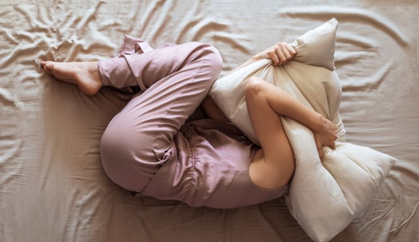 A woman laying on a bed with a pillow.