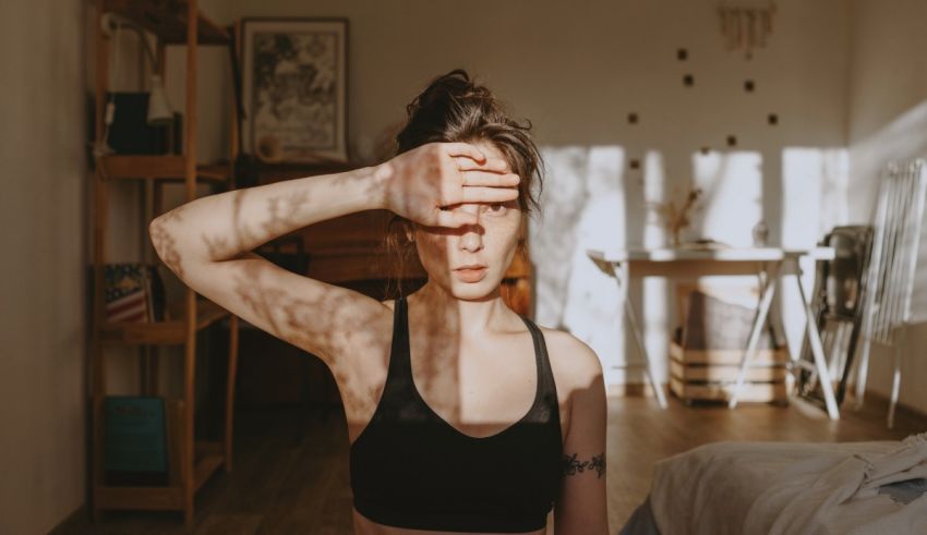 A woman with her hand over her face.