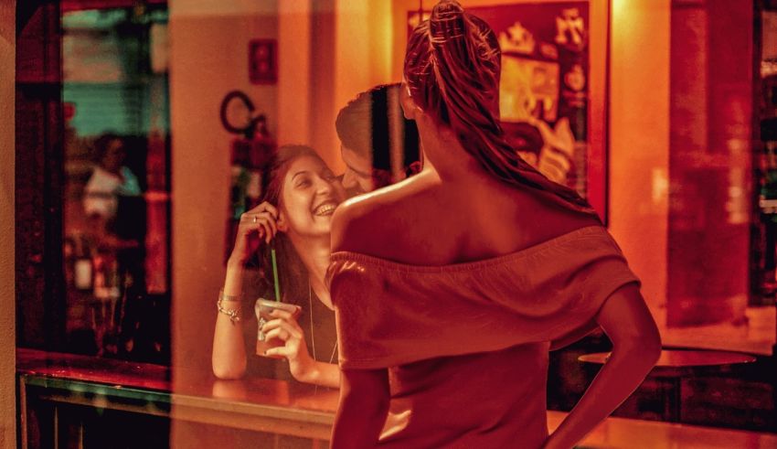 A woman in a red dress standing in front of a bar.