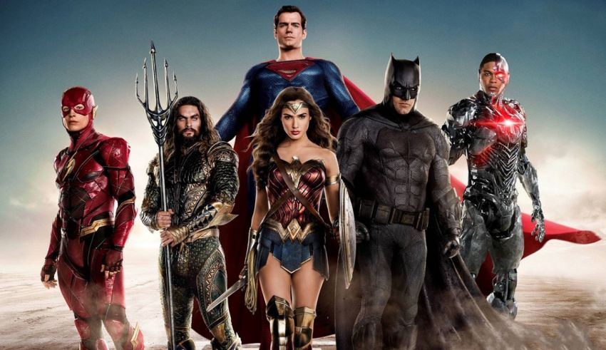 Justice league is a group of superheroes standing in front of a desert.