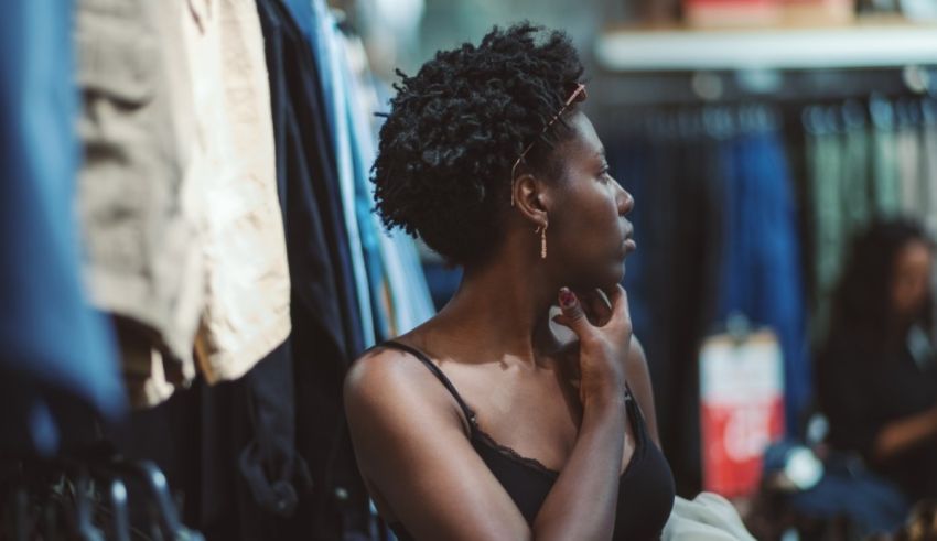 A woman looking at clothes in a clothing store.