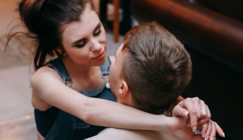 A man and woman hugging each other in a restaurant.