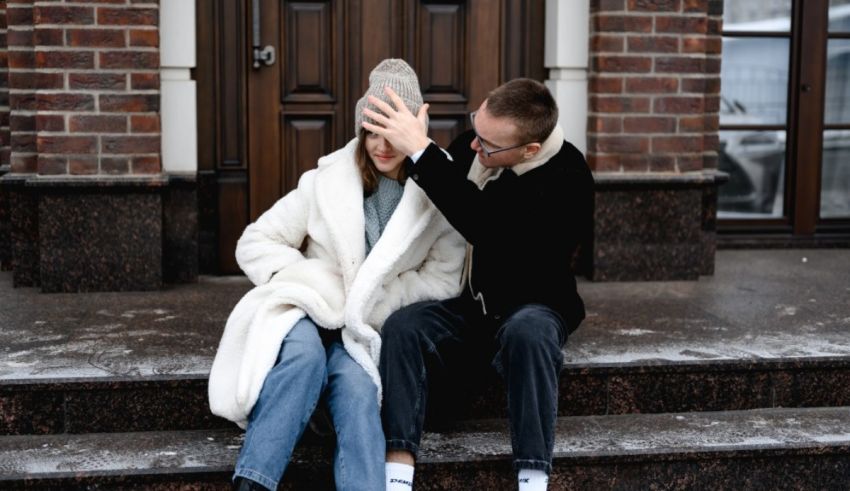 A couple sitting on the steps of a building.