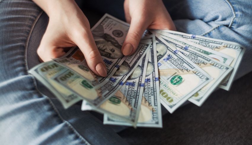 A woman is holding a bunch of money in her hands.