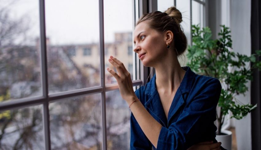 A young woman looking out of a window.