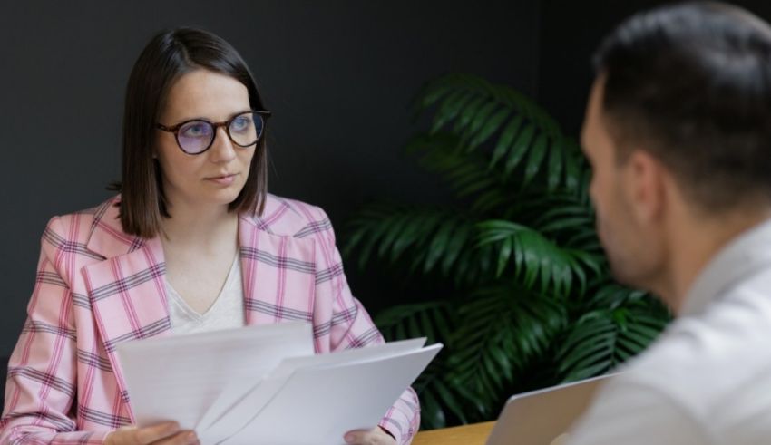 A woman is talking to a man in an office.