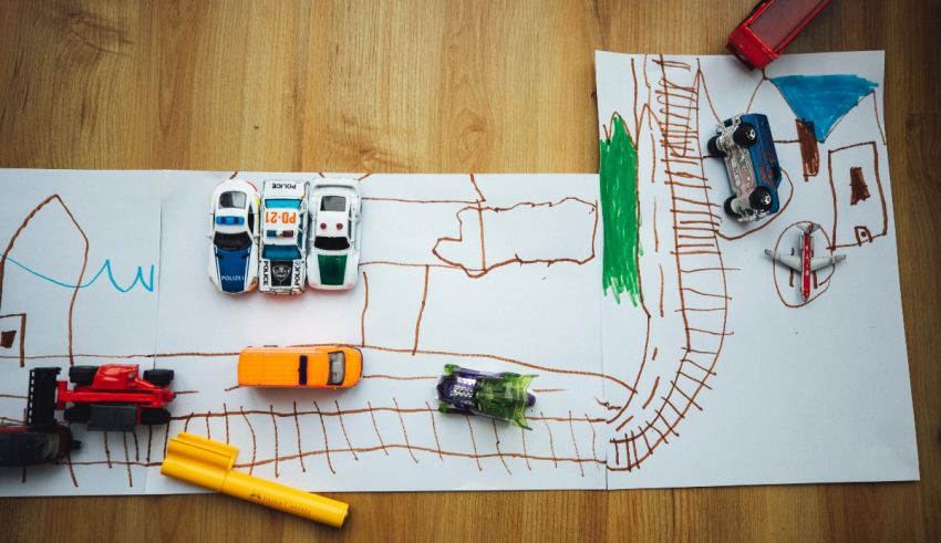 A child's drawing of a toy car on a wooden table.