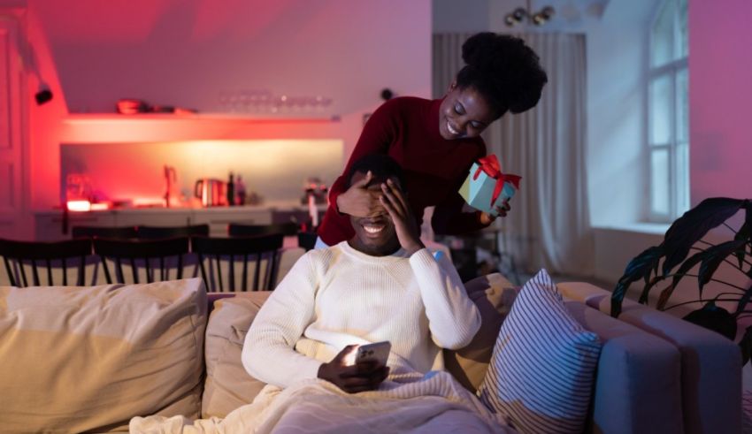 A man and woman are sitting on a couch in a living room.