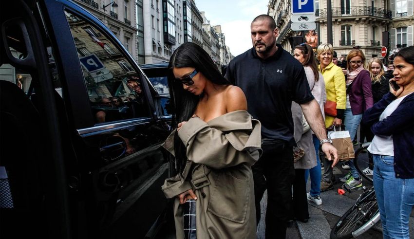 A woman is getting out of a car on a street.