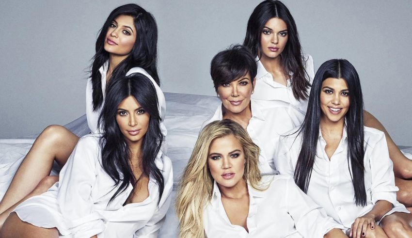 A group of women posing on a bed.