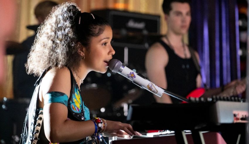 A girl playing a keyboard in front of a group of people.