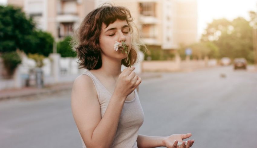 A woman is smoking a cigarette in the street.