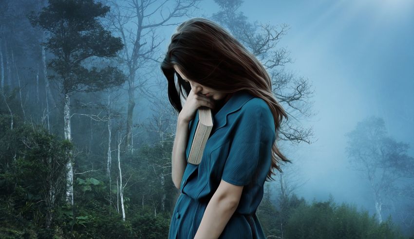 A woman in a blue dress standing in a forest.
