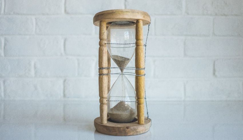 A sand clock on a white surface.