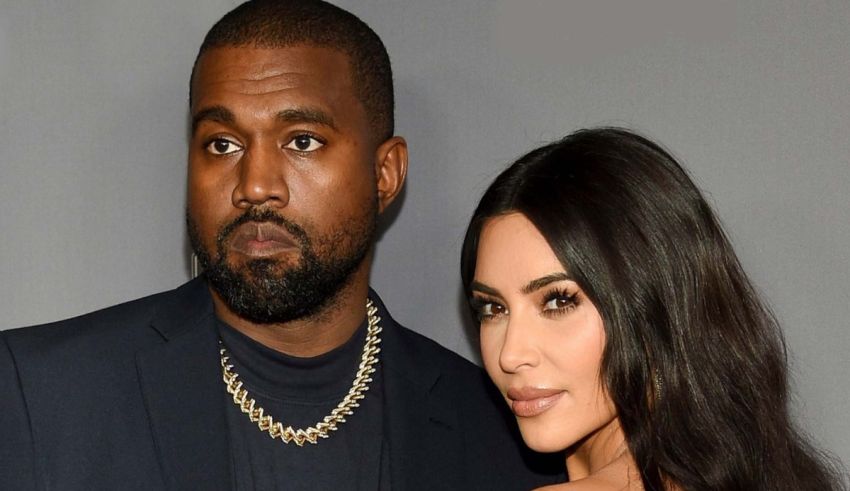 Kanye west and kim kardashian pose for a photo.