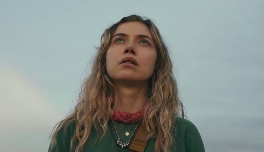 A woman with long hair looking up at the sky.