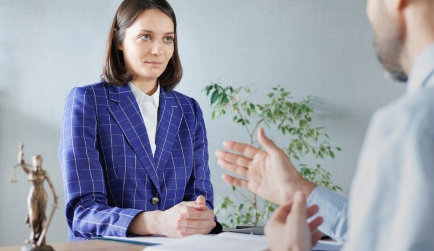 A woman is talking to a lawyer in an office.